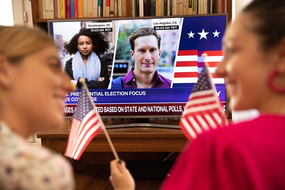 Election party of two women watching a screen