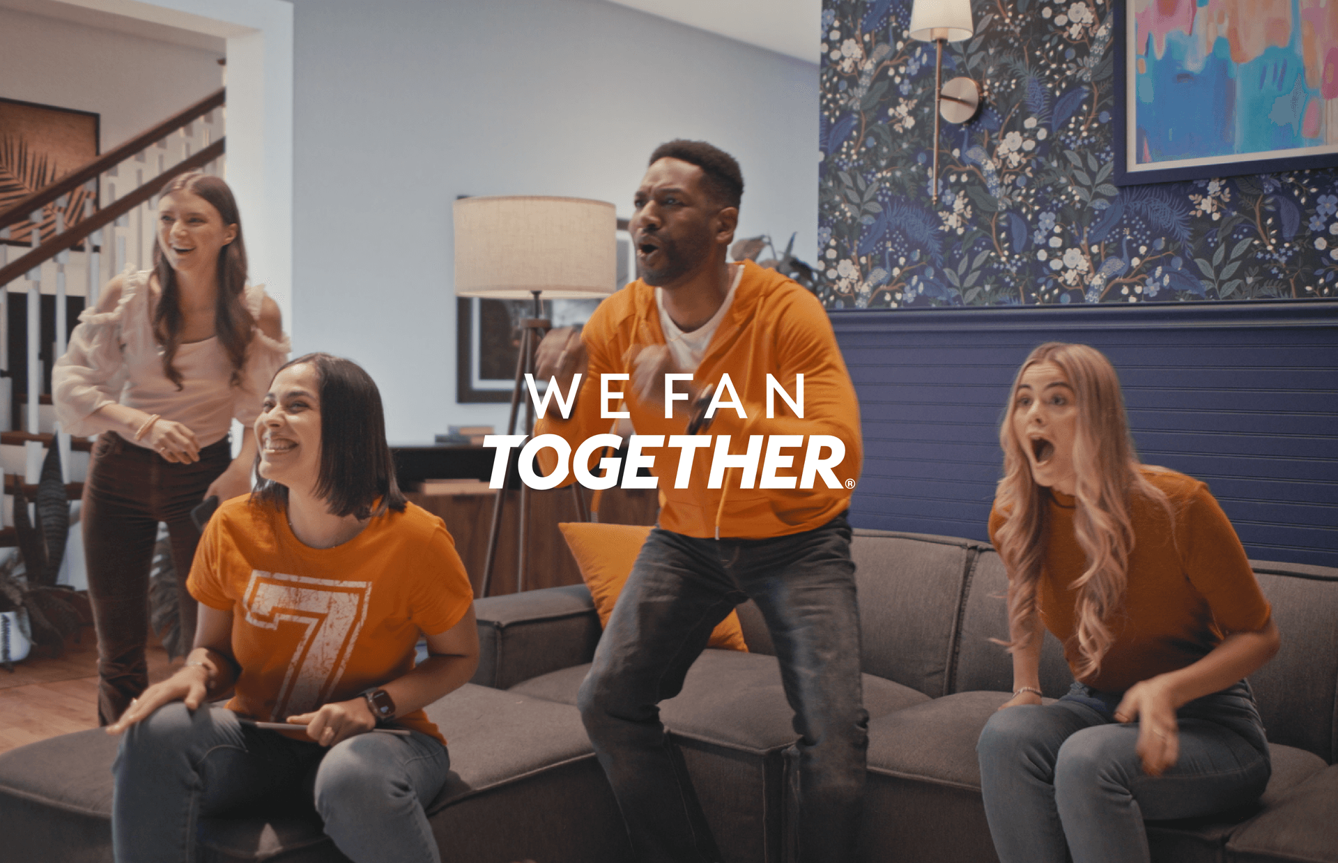 friends watching sports event on tv, celebrating a good play