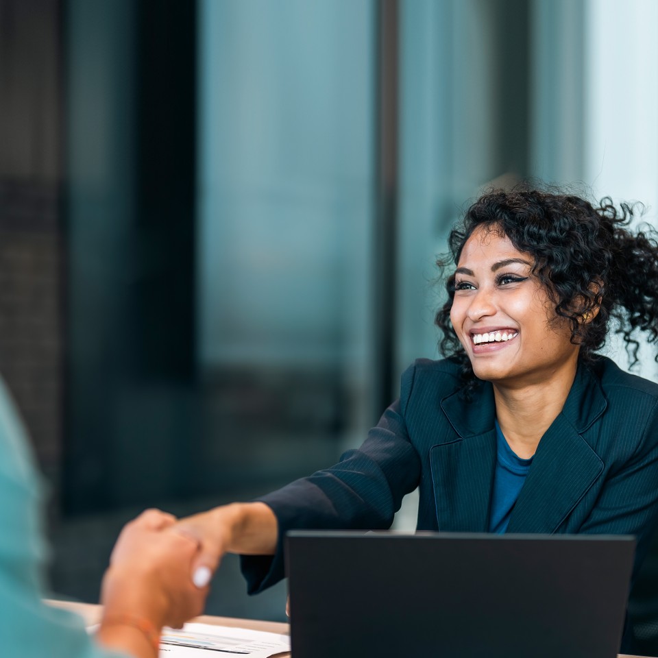 business women shaking hands with a big smile 