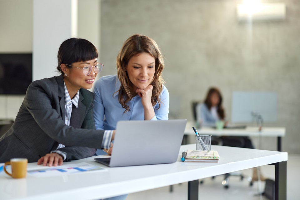coworkers looking at a computer screen