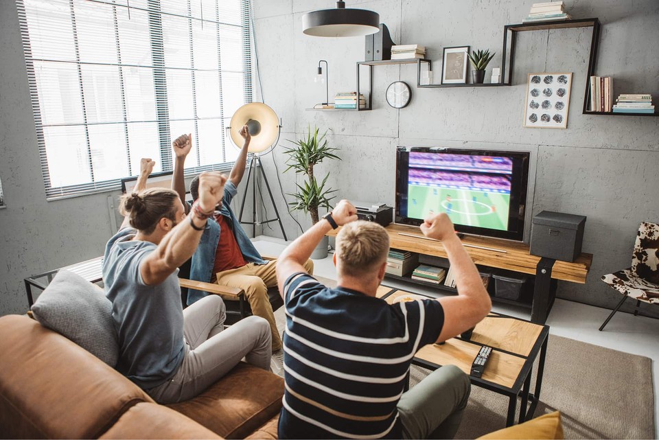 Cheering fans watching sports advertising